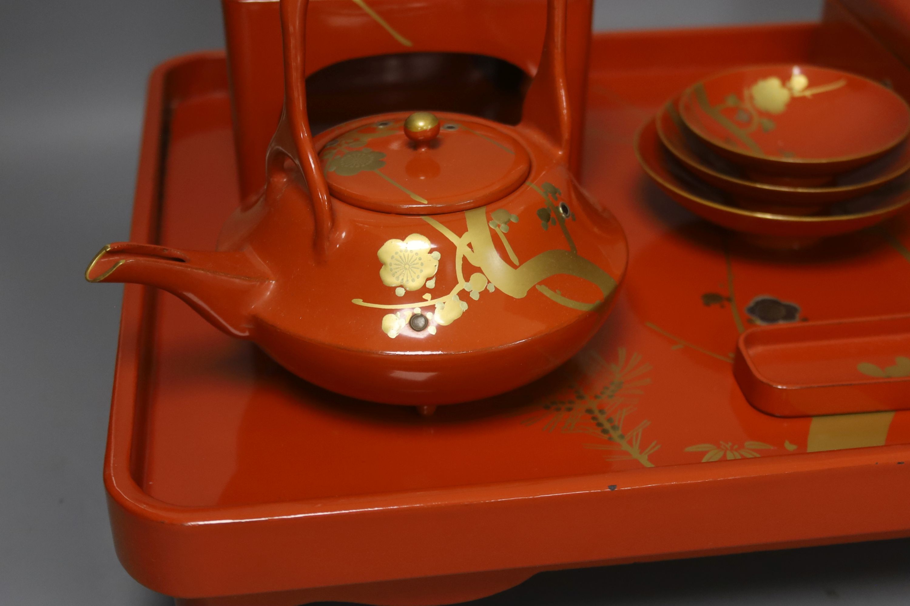 A Japanese red lacquer ceremonial sake set